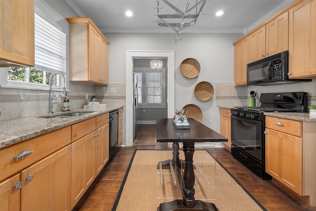 kitchen featuring ornamental molding, light stone countertops, sink, and black appliances