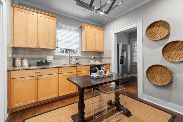 kitchen with sink, stainless steel fridge with ice dispenser, dishwasher, light stone countertops, and backsplash