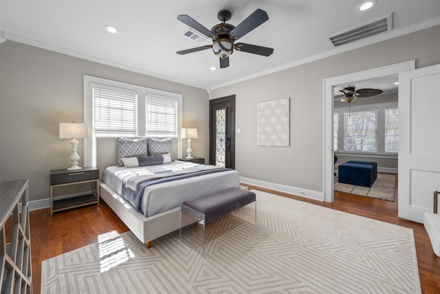 bedroom featuring ceiling fan, ornamental molding, and wood-type flooring