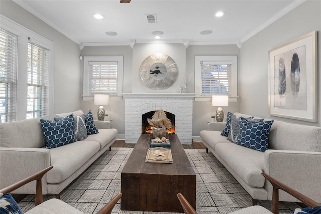 living room featuring hardwood / wood-style flooring, crown molding, ceiling fan, and a fireplace