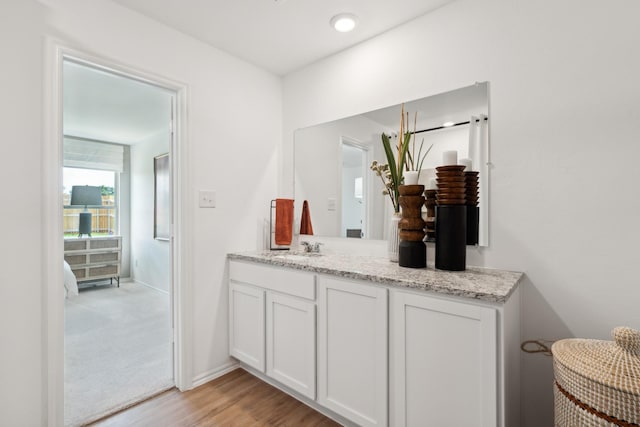 bathroom with vanity and hardwood / wood-style floors