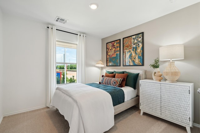 bedroom featuring light carpet