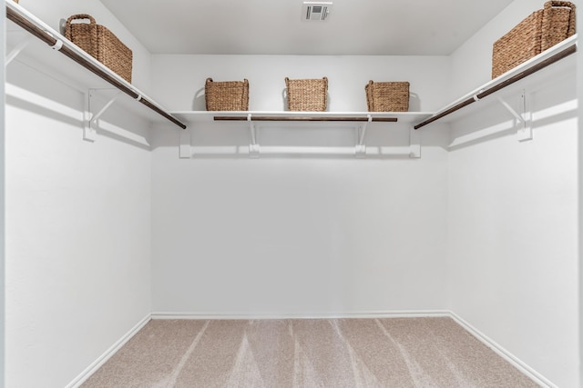 walk in closet featuring carpet