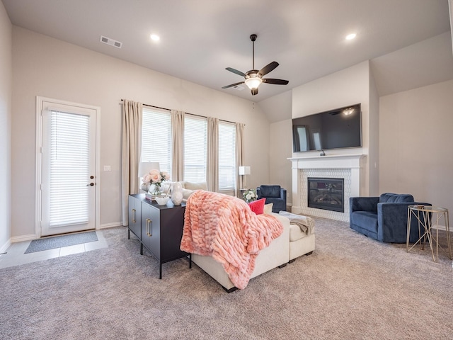 living room with light carpet, lofted ceiling, and ceiling fan