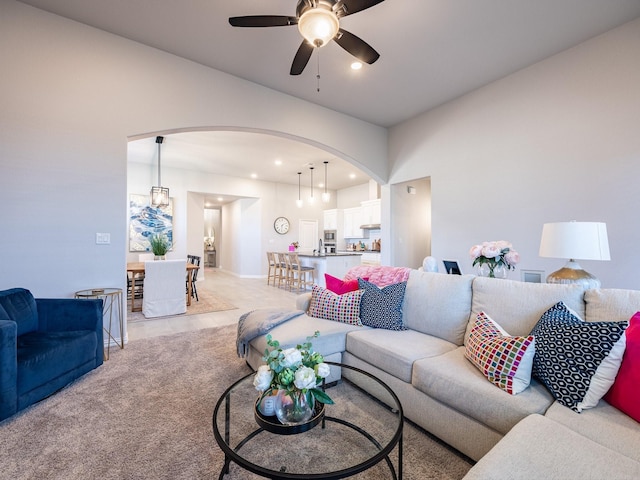 living room with light carpet and ceiling fan