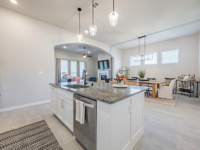 kitchen with sink, dishwasher, a kitchen island with sink, white cabinets, and stone countertops