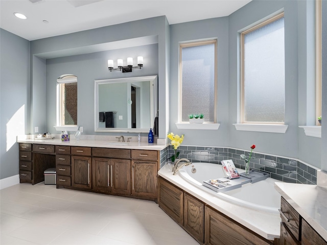 bathroom with tile patterned floors, vanity, and a tub