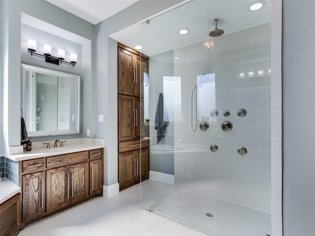 bathroom with vanity, tile patterned flooring, and a tile shower