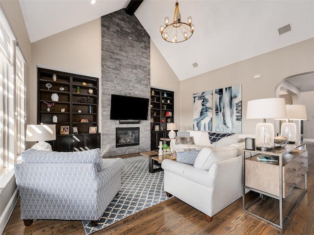 living room with a stone fireplace, high vaulted ceiling, dark hardwood / wood-style flooring, a notable chandelier, and beam ceiling