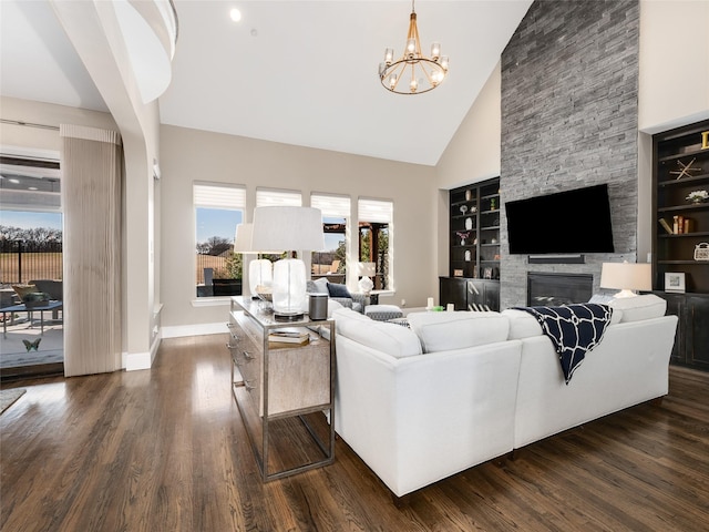 living room with dark hardwood / wood-style flooring, high vaulted ceiling, and built in features