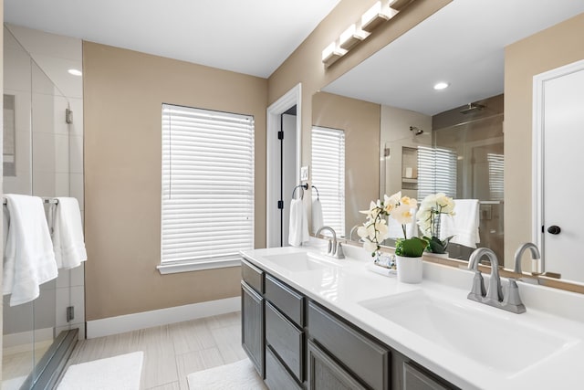 bathroom with vanity and a shower with shower door