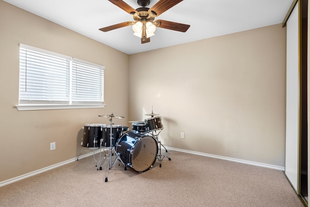 misc room featuring ceiling fan and carpet