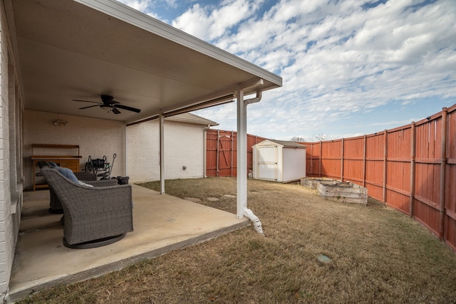 view of yard with ceiling fan, a patio, and a shed