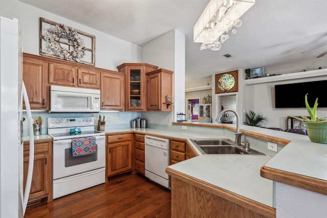 kitchen featuring sink, white appliances, and kitchen peninsula