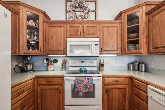 kitchen with tasteful backsplash and white appliances