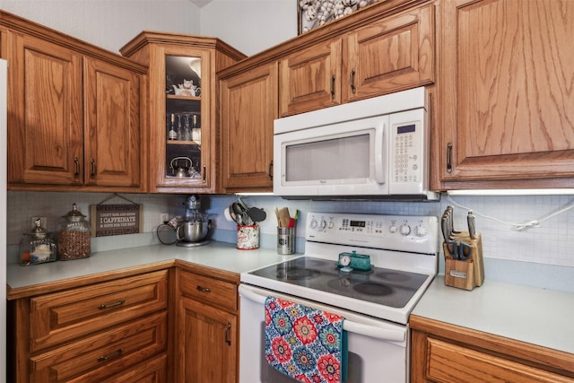 kitchen featuring backsplash and white appliances