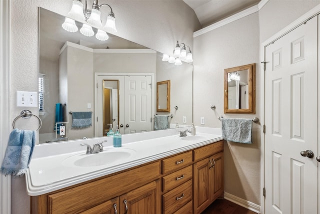 bathroom featuring vanity, crown molding, and an inviting chandelier