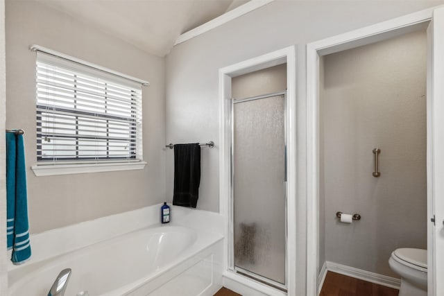 bathroom featuring hardwood / wood-style flooring, toilet, and plus walk in shower