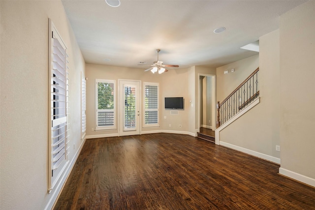 unfurnished living room featuring dark hardwood / wood-style flooring and ceiling fan