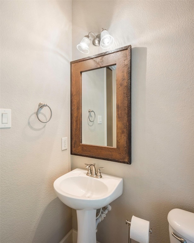 bathroom featuring sink and toilet