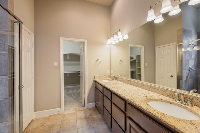 bathroom featuring vanity, a towering ceiling, an enclosed shower, and tile patterned floors