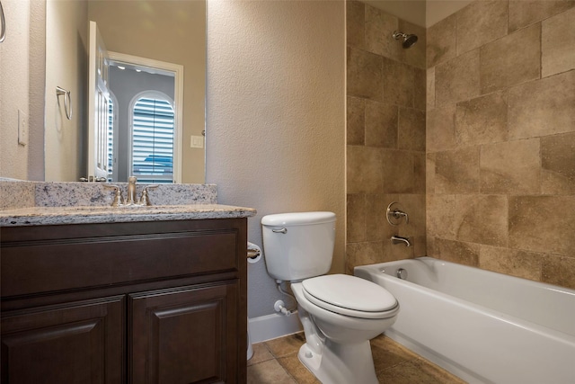 full bathroom with tile patterned floors, vanity, toilet, and tiled shower / bath combo