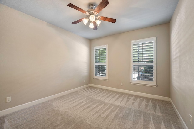 unfurnished room with light carpet and ceiling fan