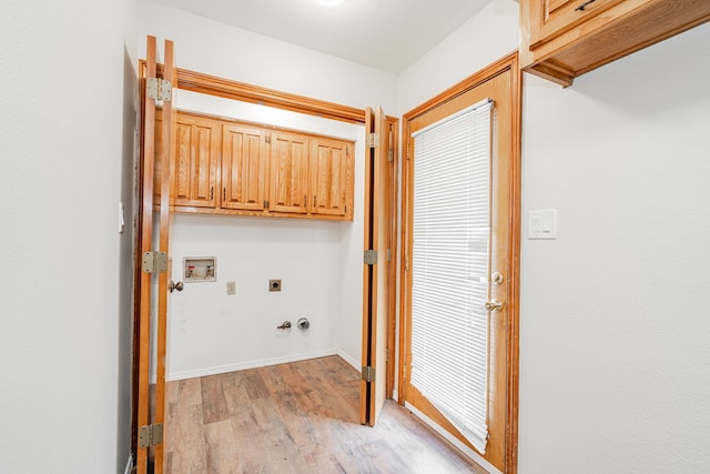 clothes washing area with cabinets, washer hookup, hookup for a gas dryer, hookup for an electric dryer, and light wood-type flooring