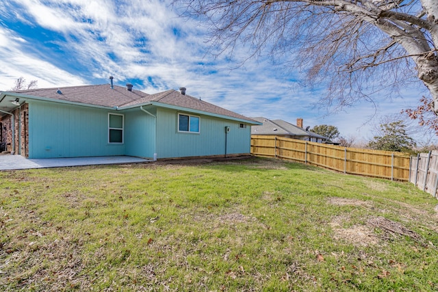 back of property with a lawn and a patio area