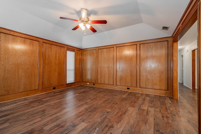 unfurnished bedroom with ceiling fan, lofted ceiling, and dark hardwood / wood-style flooring