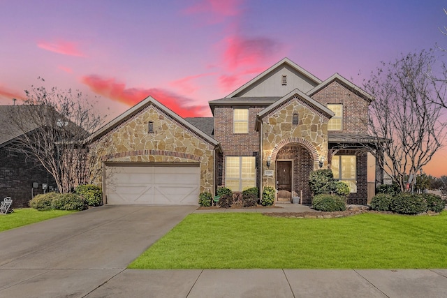 view of front of property with a garage and a yard