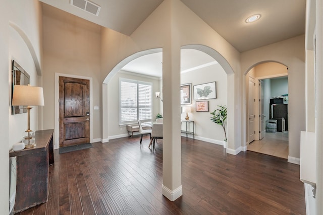 entrance foyer featuring dark hardwood / wood-style flooring and vaulted ceiling