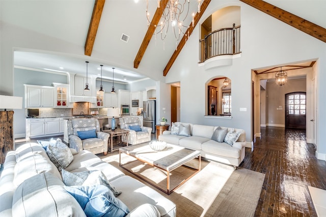 living room with dark hardwood / wood-style flooring, a notable chandelier, high vaulted ceiling, and beamed ceiling