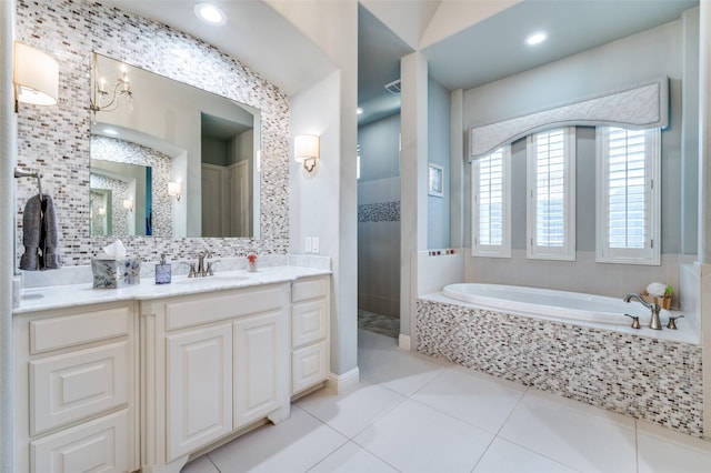 bathroom with vanity, backsplash, tile patterned floors, and plus walk in shower