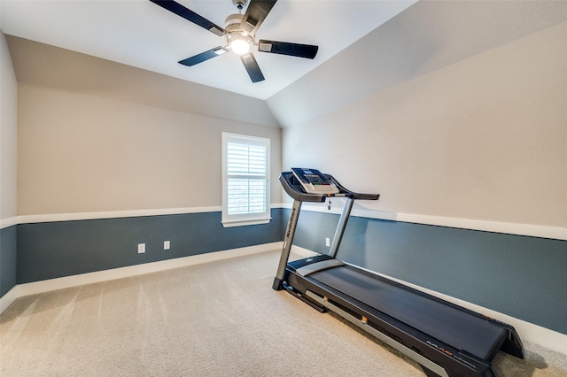 workout room featuring vaulted ceiling, ceiling fan, and carpet flooring