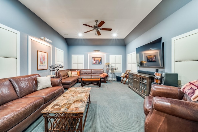 carpeted living room featuring ceiling fan