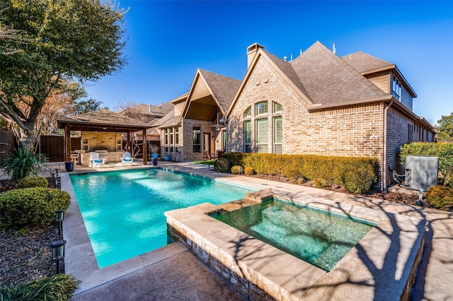 view of pool featuring a gazebo, an in ground hot tub, and a patio