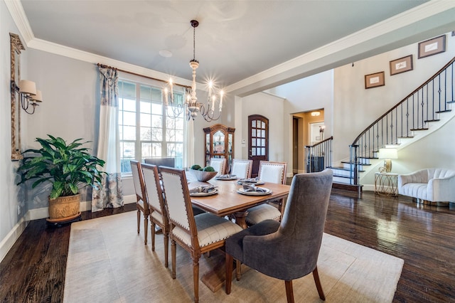 dining area with an inviting chandelier, hardwood / wood-style floors, and crown molding