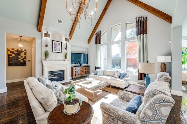 living room featuring beam ceiling, dark wood-type flooring, high vaulted ceiling, and a chandelier