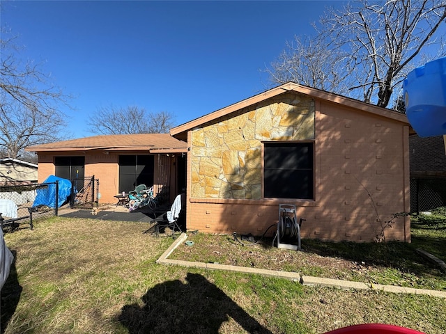 back of house featuring a yard and a patio