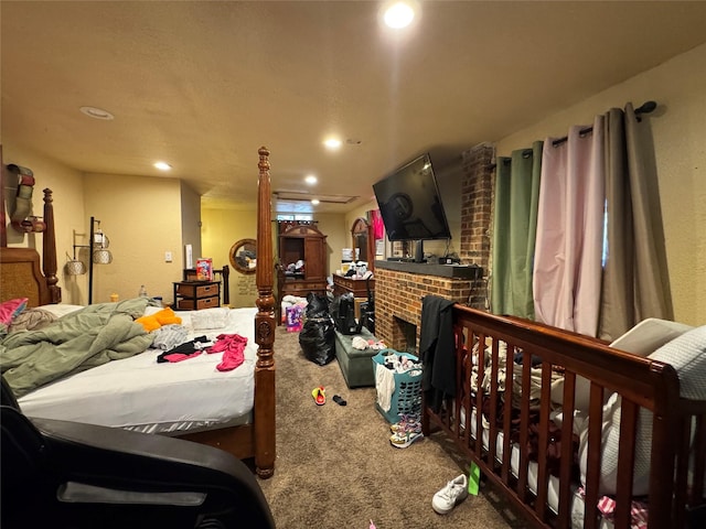 bedroom featuring a brick fireplace and carpet flooring