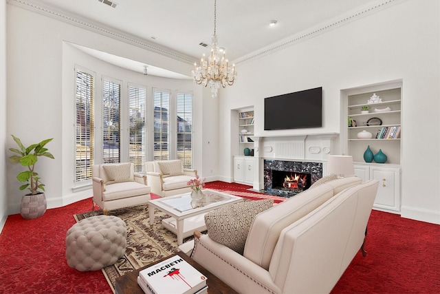 carpeted living room featuring a high end fireplace, built in features, and a chandelier