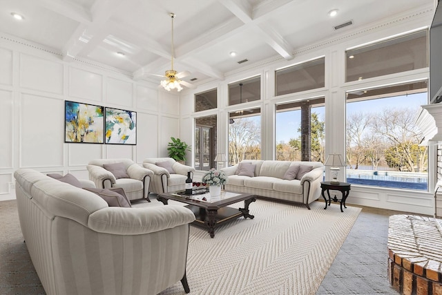 living room featuring coffered ceiling, ceiling fan, beam ceiling, and a towering ceiling