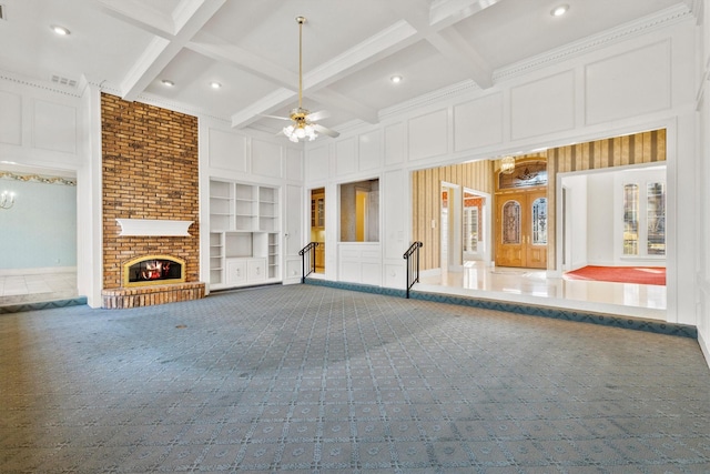 unfurnished living room with beamed ceiling, coffered ceiling, carpet floors, and built in features