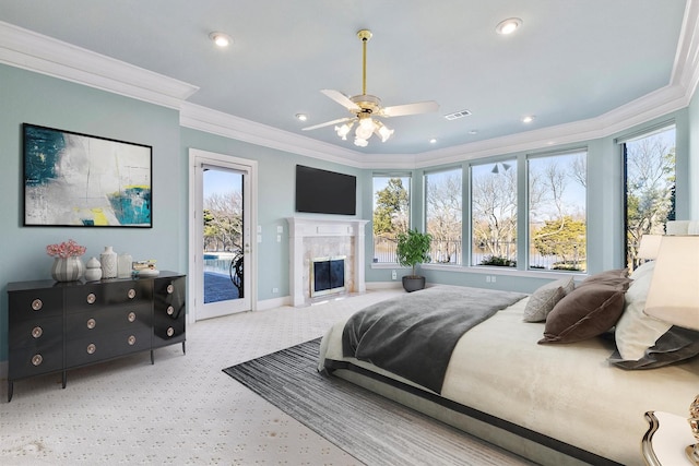 bedroom with visible vents, a premium fireplace, ornamental molding, access to exterior, and carpet flooring