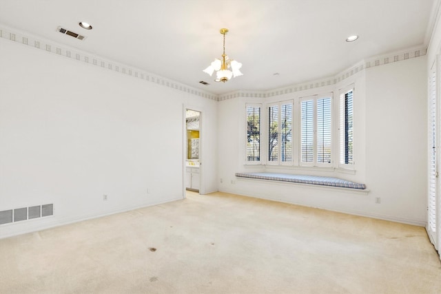 carpeted empty room featuring a notable chandelier and ornamental molding