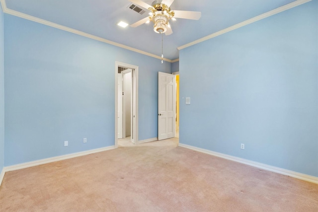 carpeted empty room with crown molding and ceiling fan