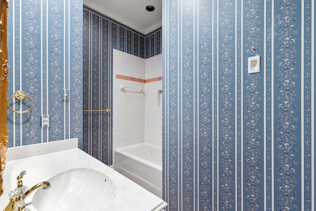 bathroom featuring crown molding, sink, and plus walk in shower