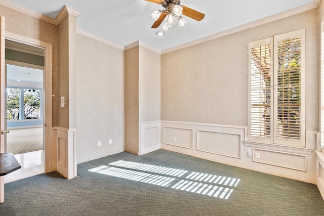 carpeted spare room with ornamental molding and ceiling fan