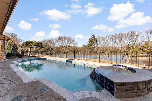 view of swimming pool with an in ground hot tub, a patio, and a water view